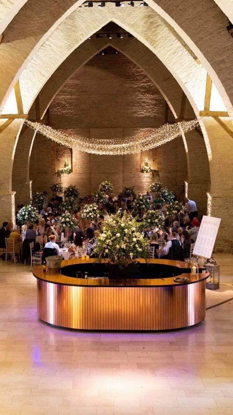 Circular copper-clad island bar in a vaulted stone barn
